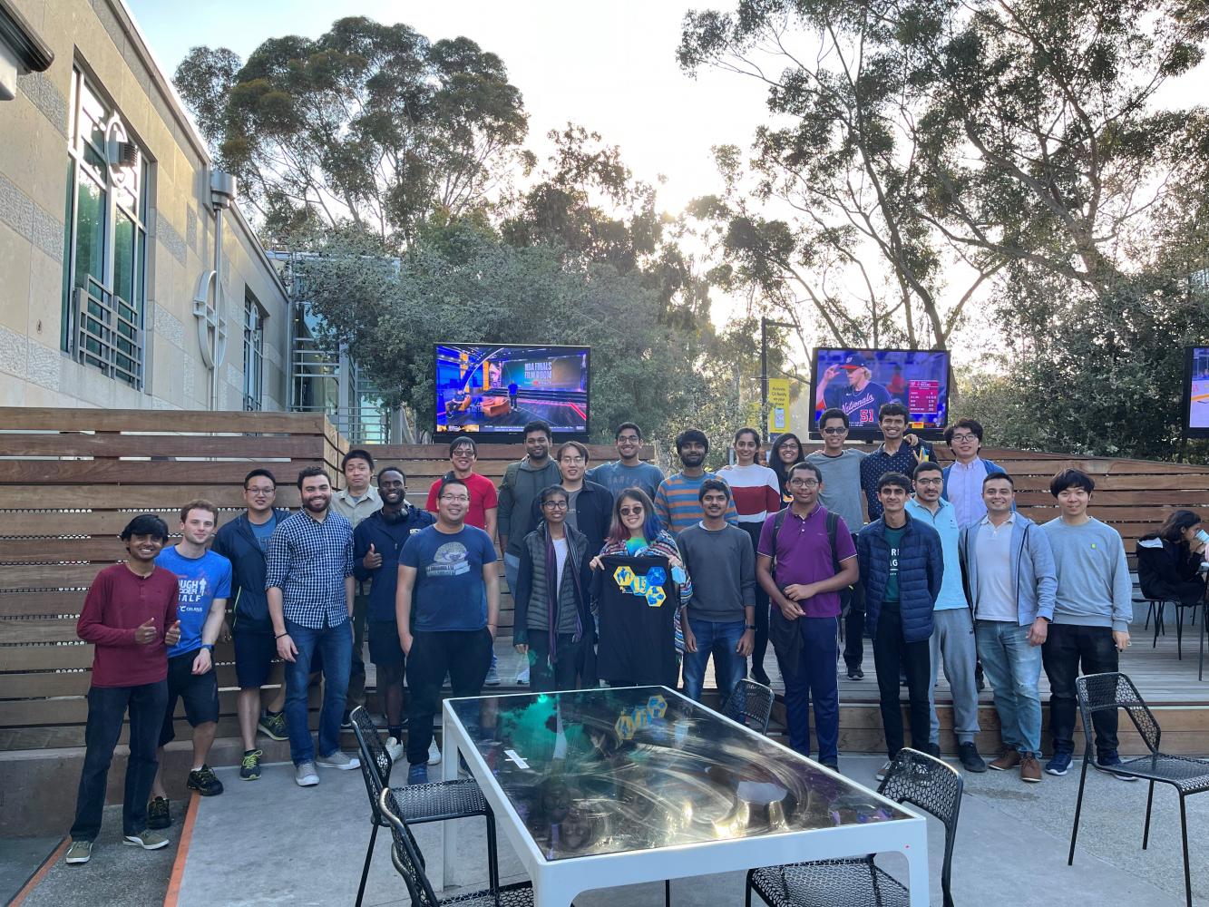 A group of about 25 RoboGrads members pose for a group photo at the end of the year social.
